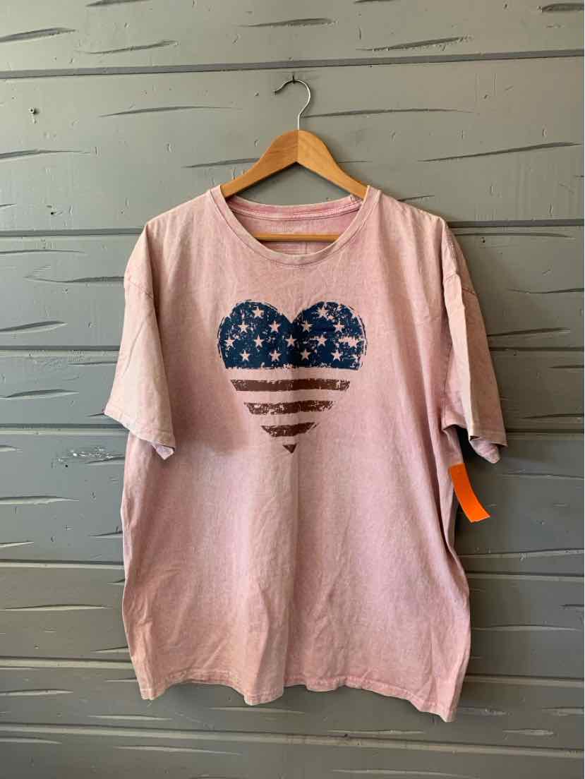Light pink oversized T-shirt with distressed American flag heart graphic on front and short sleeves.
