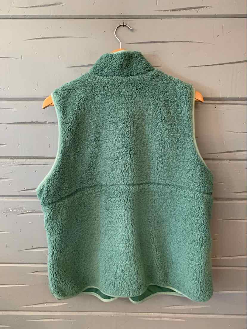 Solid teal-green sleeveless fleece vest with a high collar, front zipper, and curved hem.