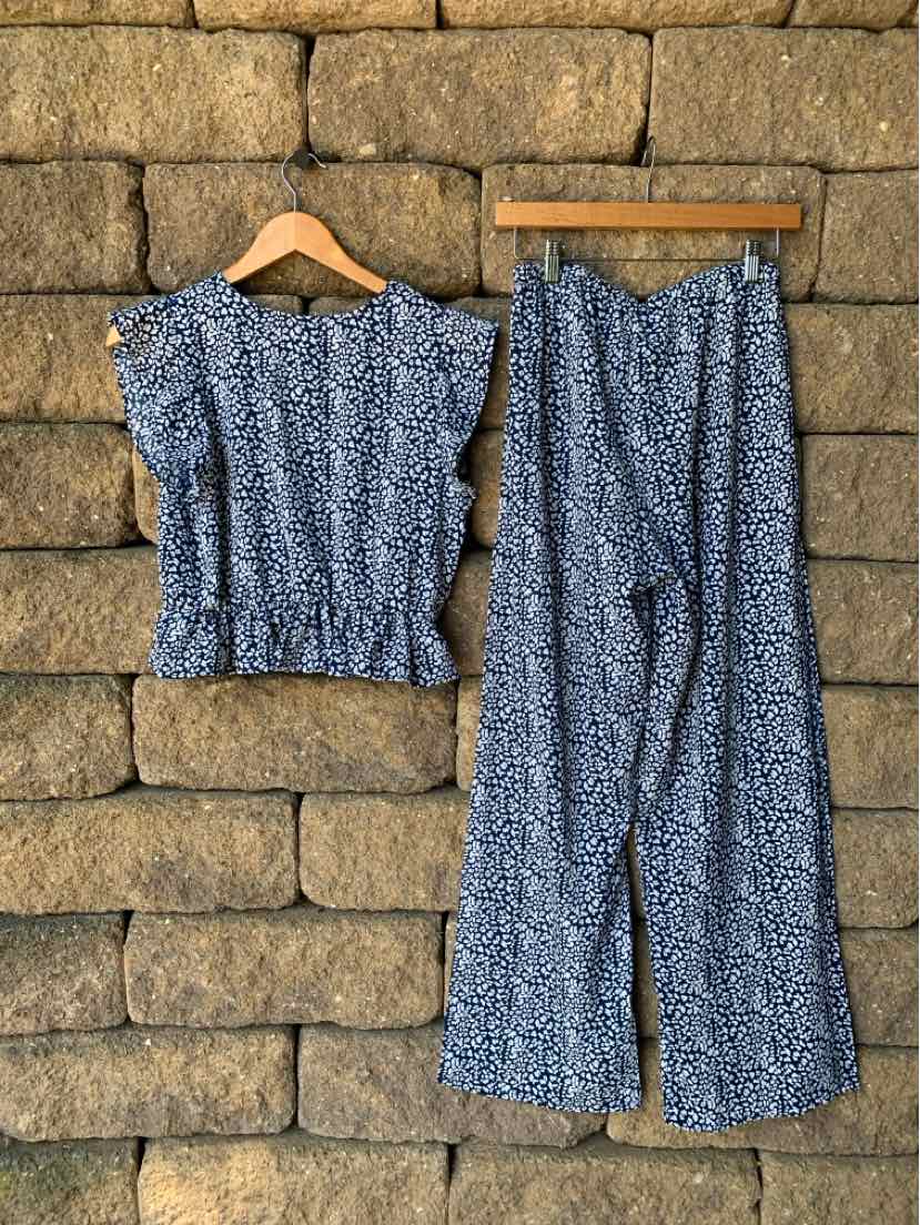 Blue floral short-sleeve blouse with ruffled sleeves and matching wide-leg pants.
