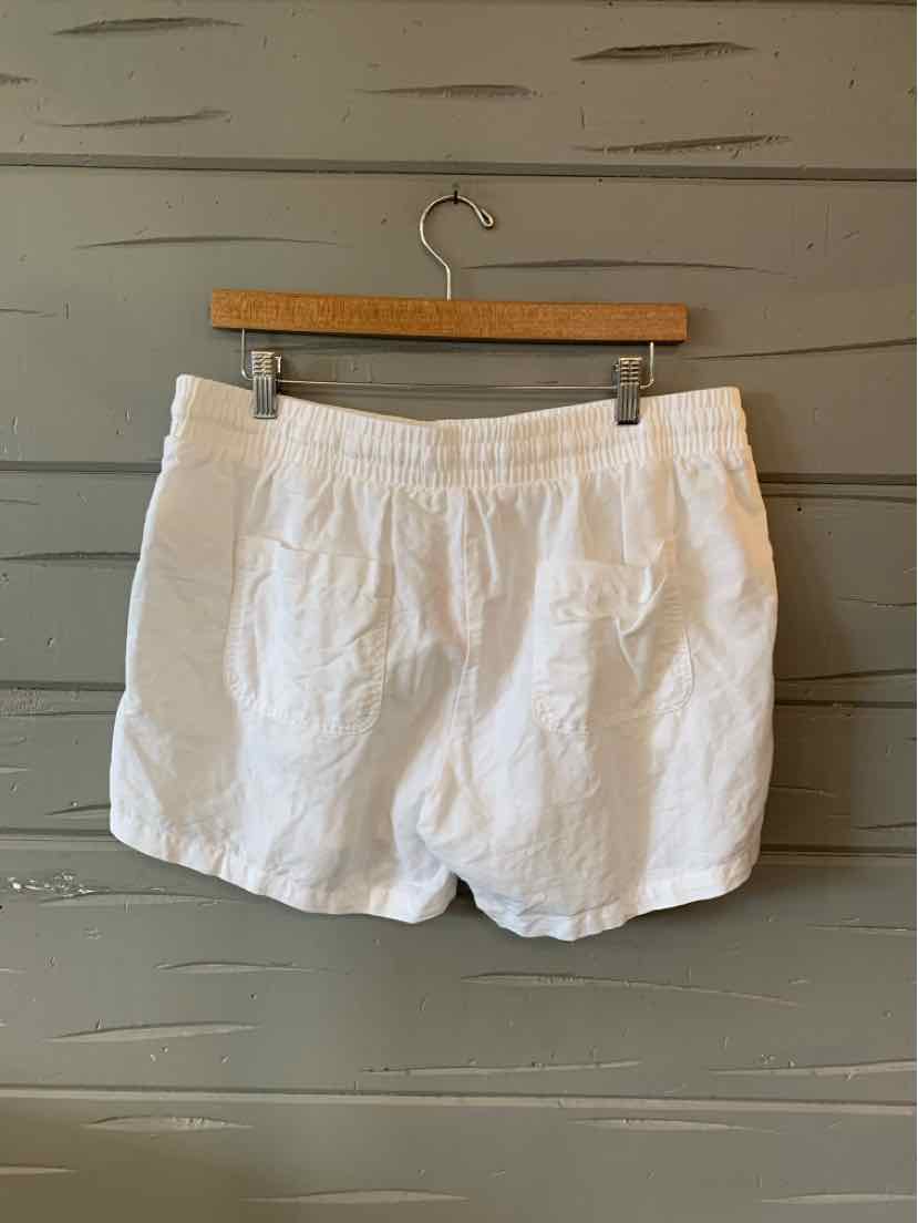 White elastic waistband shorts with side pockets, lightweight cotton fabric, relaxed fit, size large.