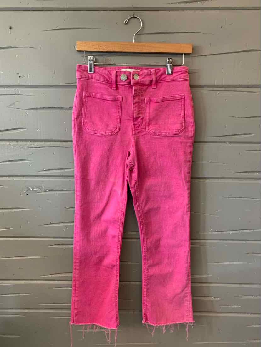 Bright pink denim jeans with front patch pockets and raw hem, high-waisted fit.