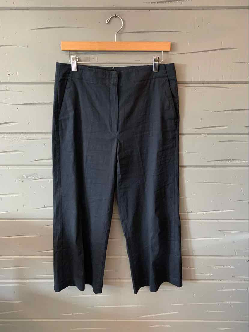 Black straight-leg trousers with belt loops and front pockets hanging on a wooden hanger.