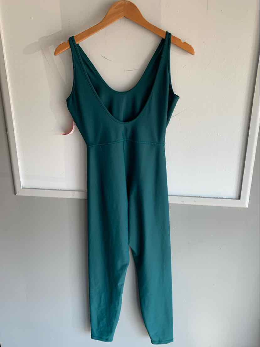 Teal sleeveless jumpsuit with scoop neckline and fitted waist hanging on wooden hanger.