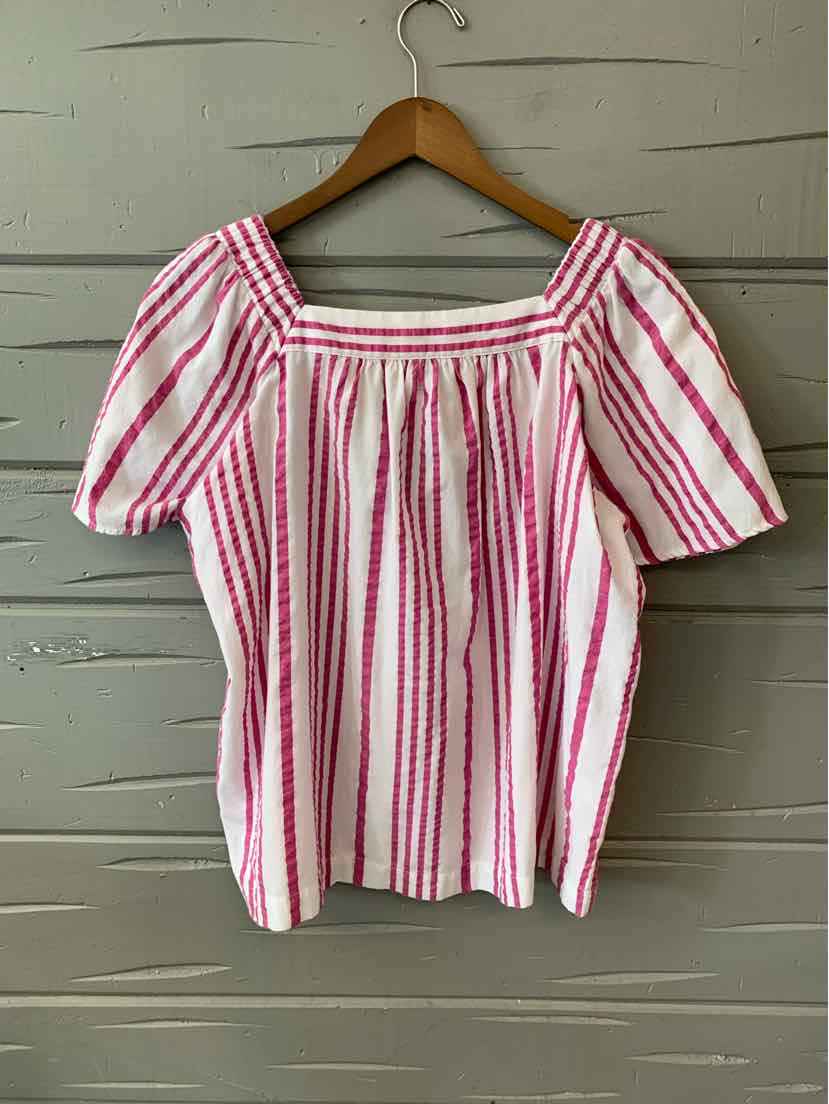 White blouse with vertical pink stripes and puffed short sleeves on wooden hanger.