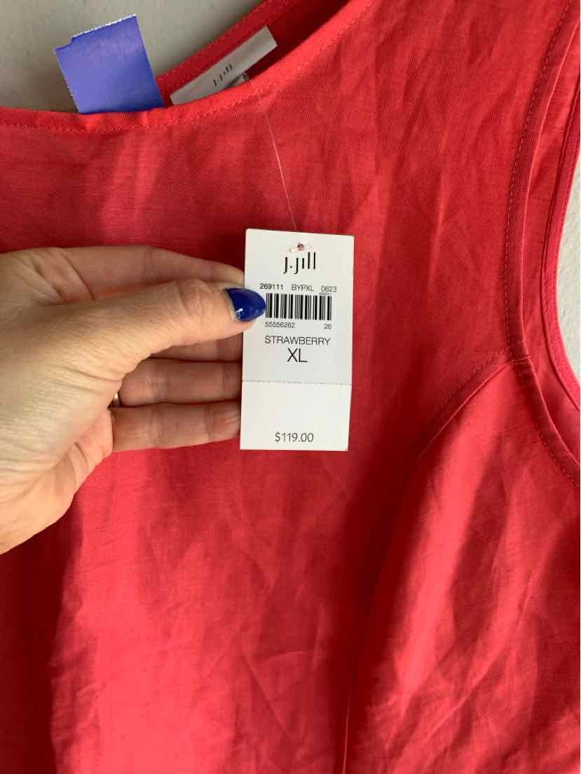 Hand holding red linen sleeveless top with JJill XL price tag showing $178.00.