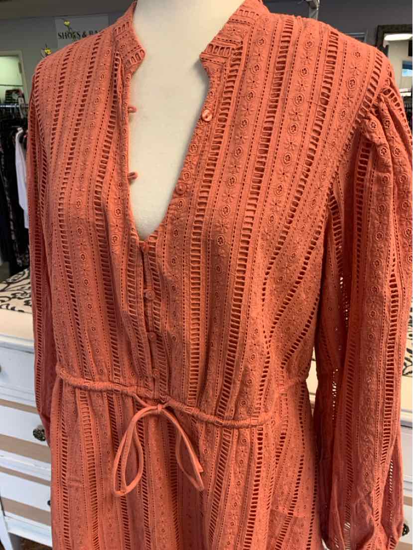 Rust orange long-sleeve blouse with textured vertical stripes and tie waist in size large.