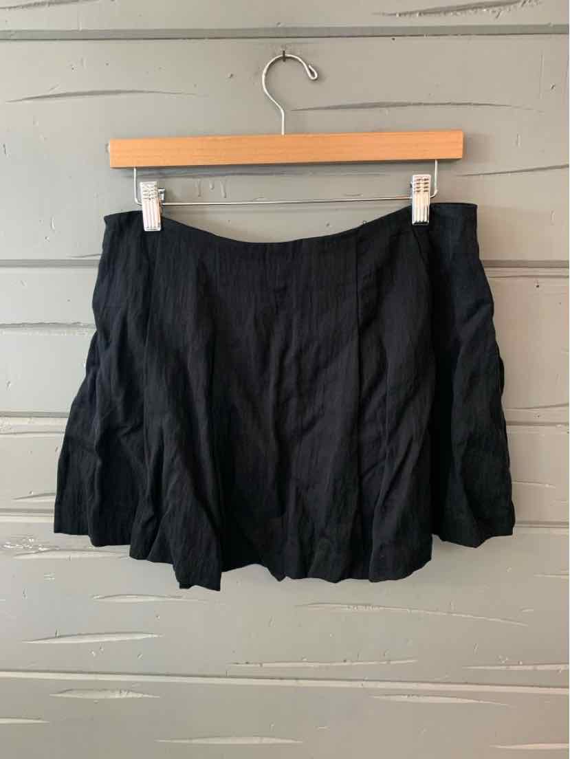 Black A-line mini skirt with soft pleats, made from lightweight fabric, size 8.