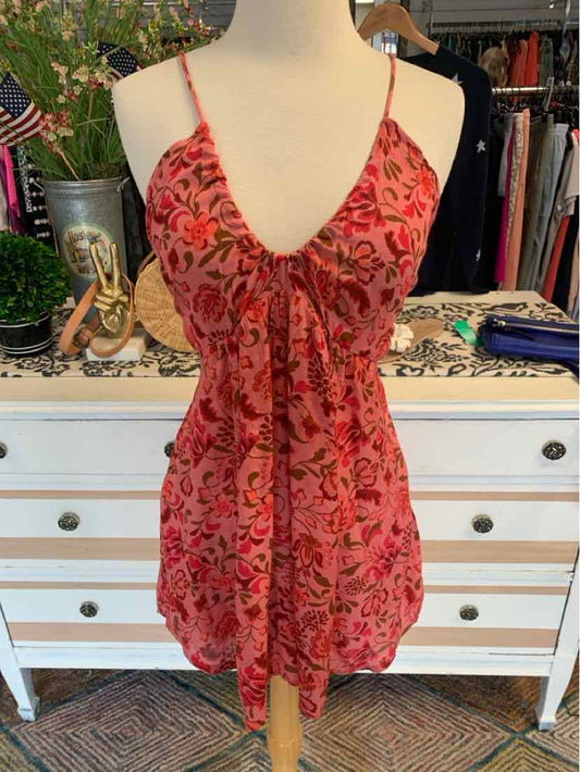 Pink floral print sleeveless dress with deep V-neck and gathered waist in medium size.