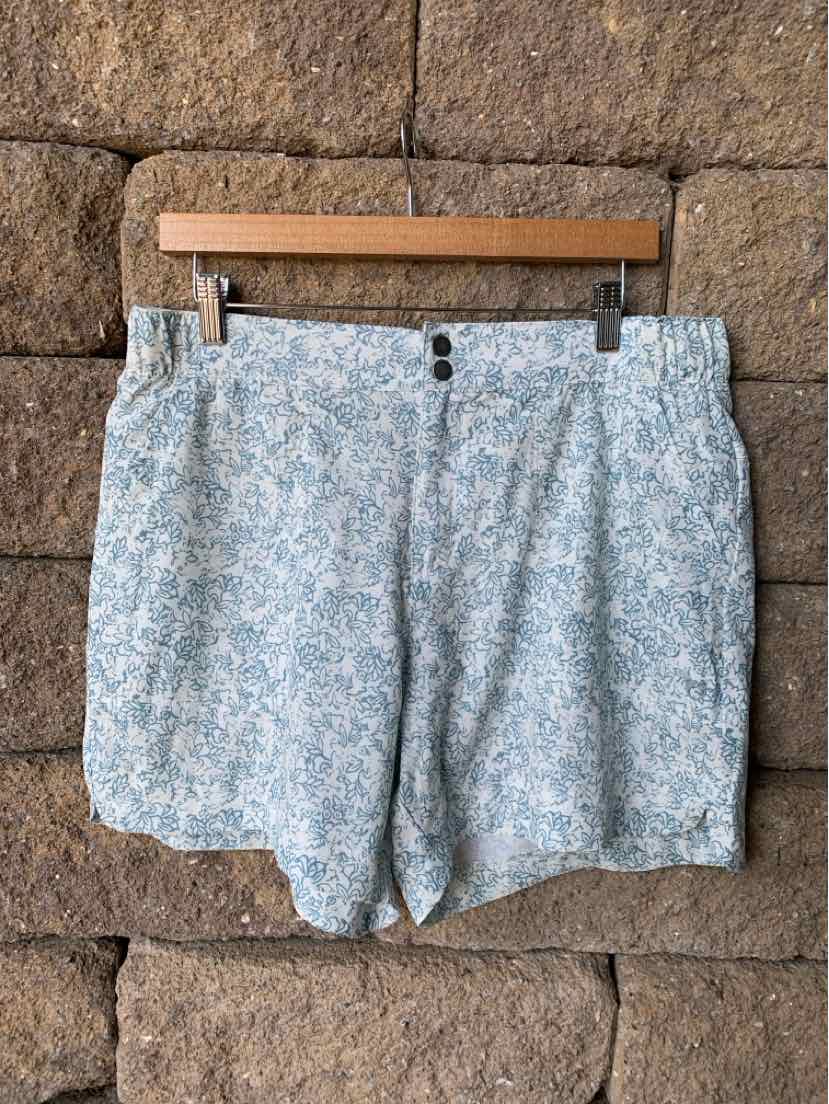 Light blue floral pattern shorts with button and zipper closure, tailored fit, size XL.