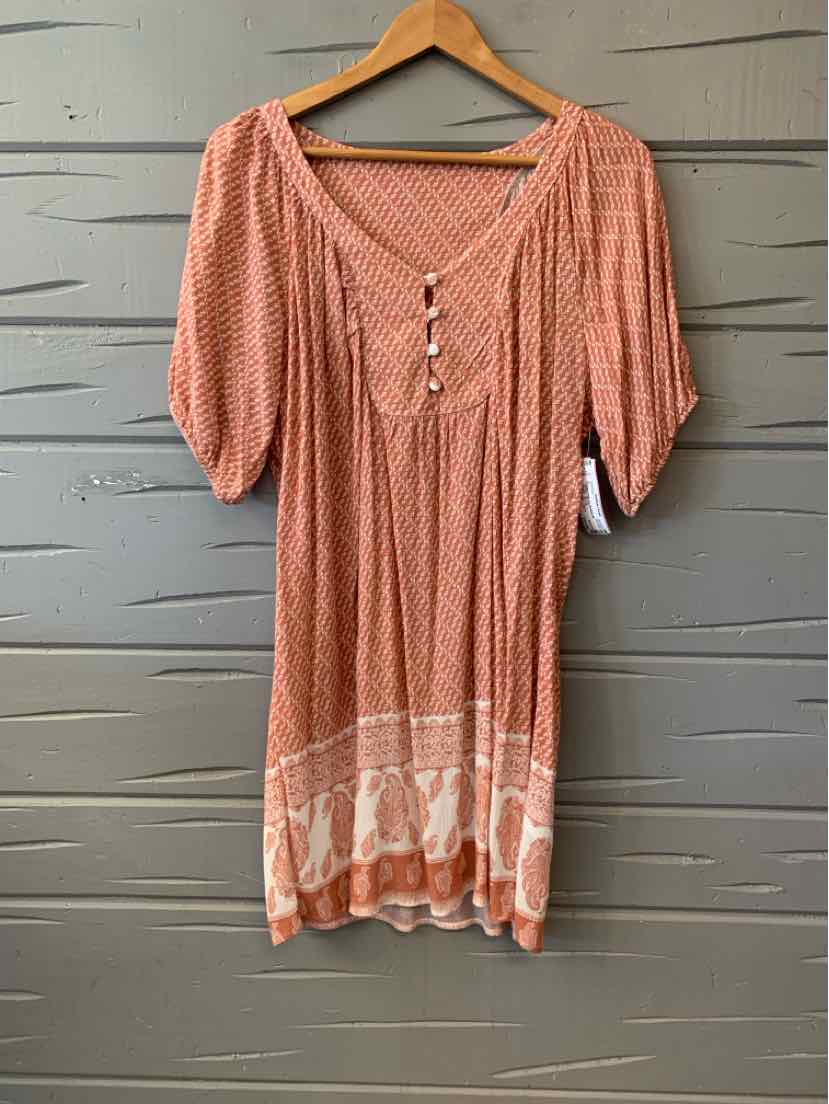 Long peach dress with white paisley print, scoop neckline, short puff sleeves, and front buttons.