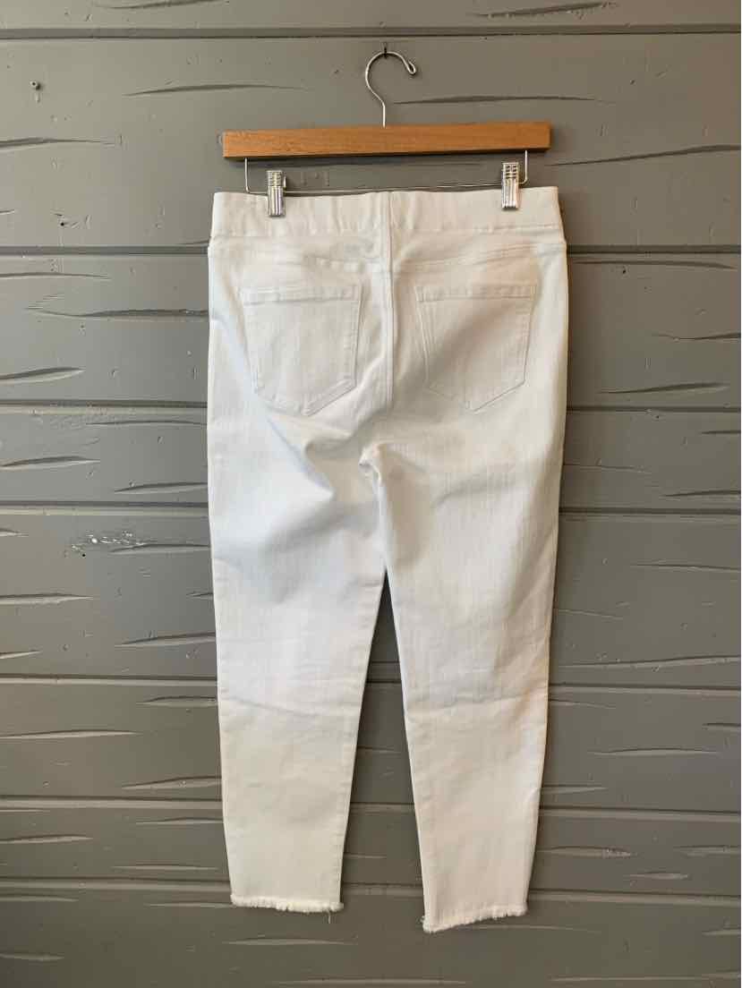 White denim jeans with a slim fit, high waist, and raw hem detailing at the ankles.