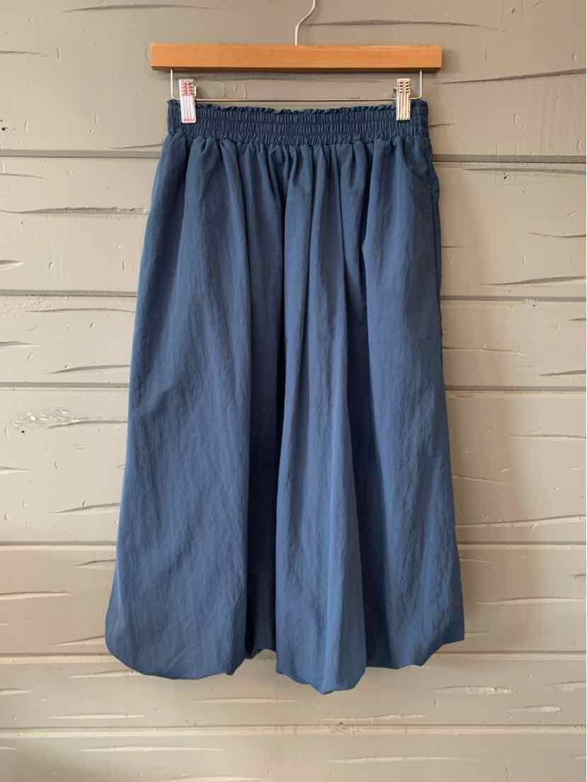 Navy blue lightweight wide-leg pants with elastic waistband in XS/S size hanging on wooden hanger.