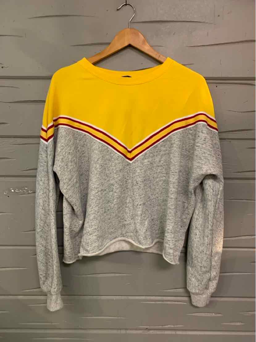 Long-sleeve color block sweatshirt with yellow upper section and gray lower body featuring red and white chevron stripe.
