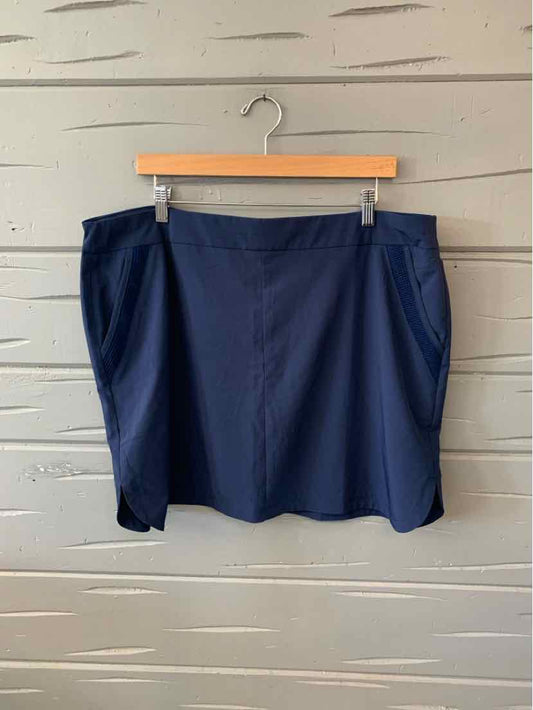 Navy blue skort with side pockets, smooth fabric, and a slight A-line shape in size XL.