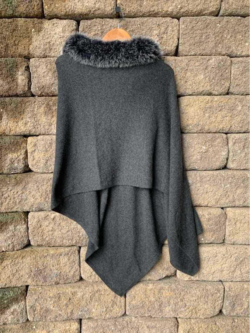 Dark gray cashmere poncho with soft fur collar, draped silhouette, and asymmetrical hem.