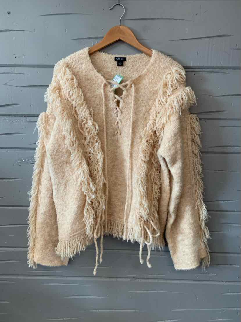 Tan knitted sweater with fringe detailing along sleeves and front, V-neckline, and long sleeves.
