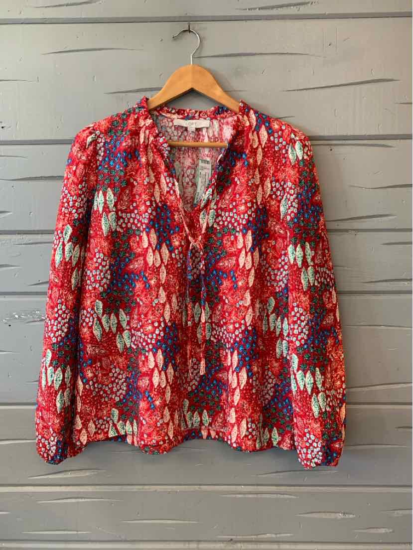 Red long-sleeve blouse with vibrant multicolor abstract pattern, lightweight fabric, relaxed fit.