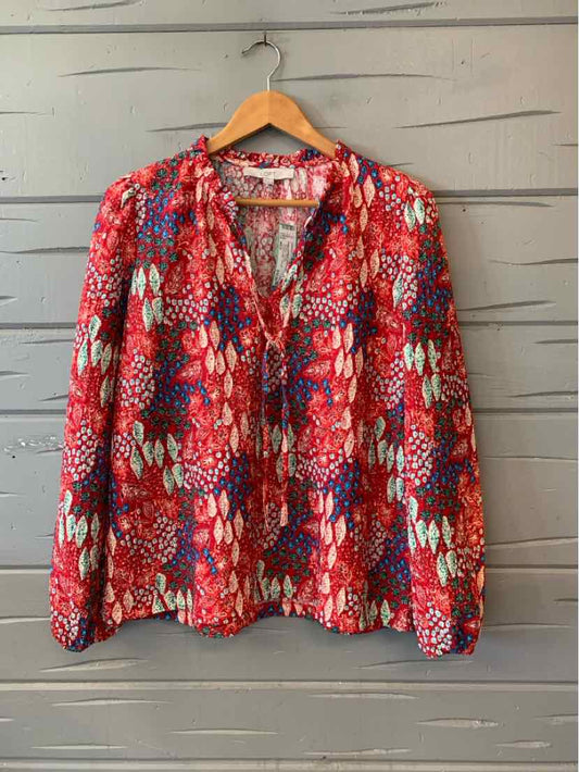 Red long-sleeve blouse with vibrant multicolor abstract pattern, lightweight fabric, relaxed fit.
