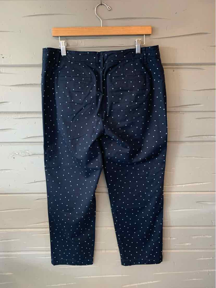 Navy blue pants with white polka dots, straight-leg fit, size 12, displayed on wooden hanger.