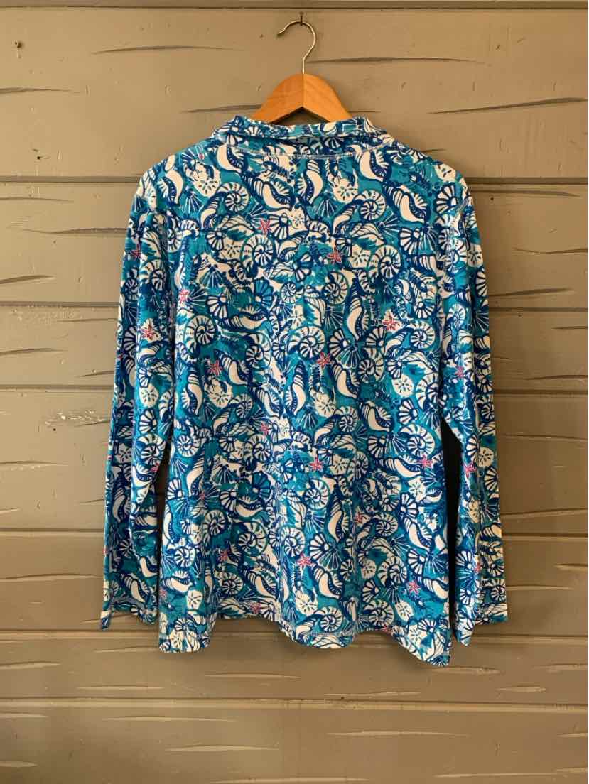 Blue long-sleeve shirt with white and light blue seashell floral pattern on wooden hanger.