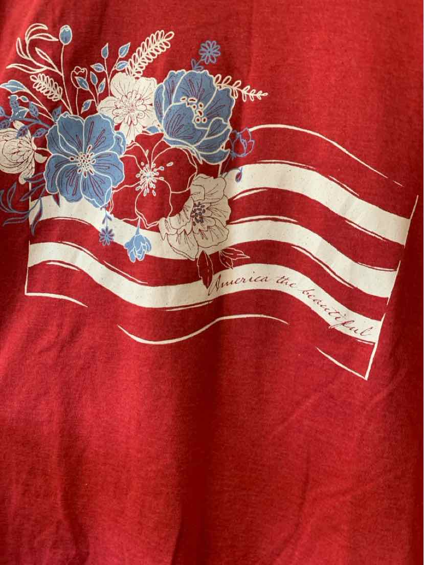 Red fabric with white stripes and blue, white floral design on the front.