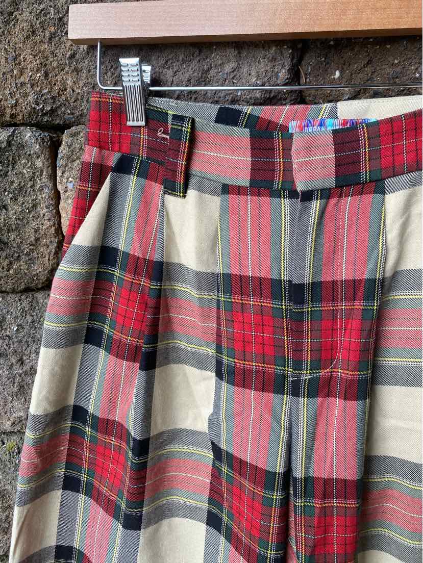 High-waist multi-color plaid skirt with red, black, beige, and green tones, pleated front design.
