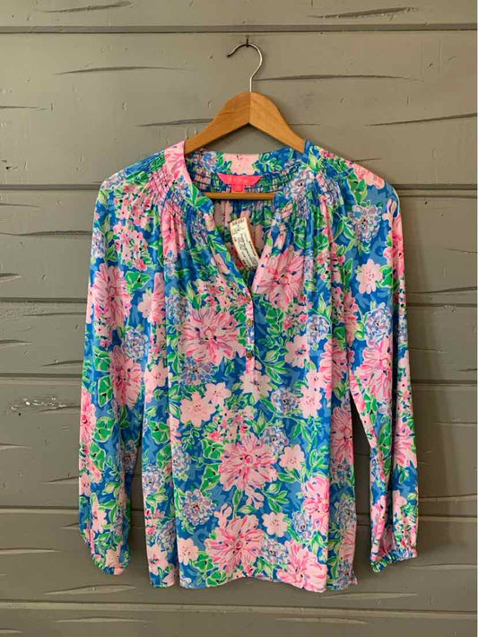 Long-sleeve blouse with vibrant pink and blue floral pattern, lightweight fabric, relaxed fit, size small.