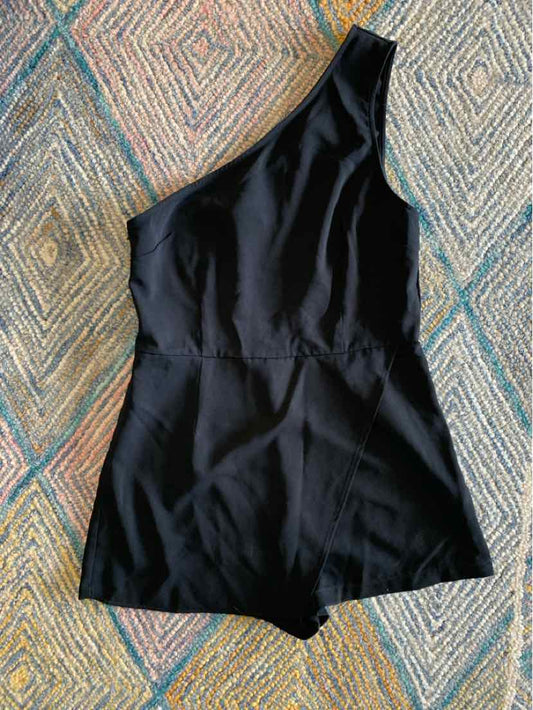Black one-shoulder sleeveless romper with fitted waist and shorts bottom.