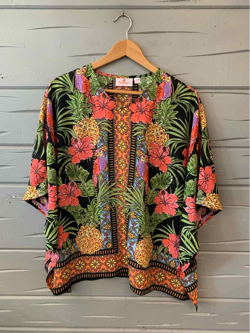 Black tropical short-sleeve blouse with bright pink flowers, green leaves, and pineapple print, bordered geometric hem.