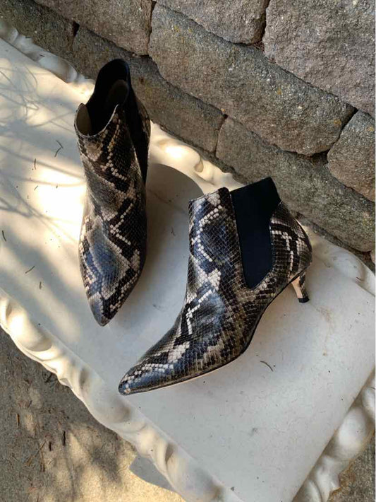 Black and white snake print leather ankle boots with pointed toes and slim heels.