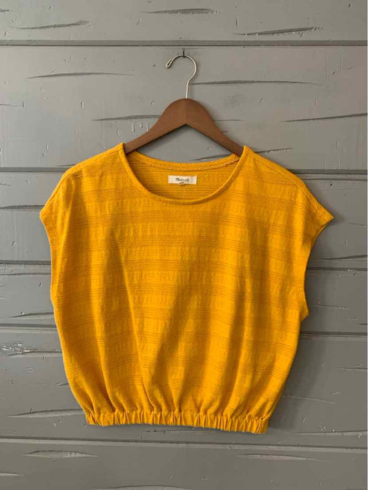 Yellow short-sleeve blouse with subtle stripes and gathered elastic hem on wooden hanger.