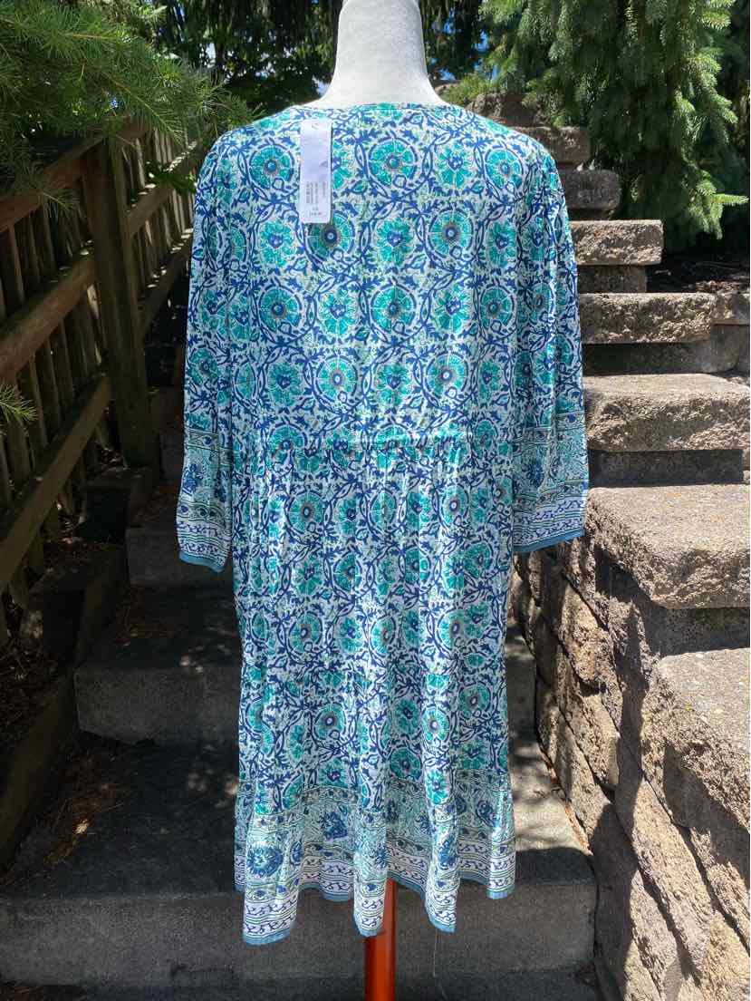 Blue and white paisley print long-sleeve dress with gathered waist and knee-length hem.
