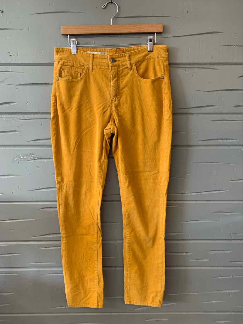 Mustard yellow straight-leg pants with front patch pockets and a high waist hanging on a wooden hanger.