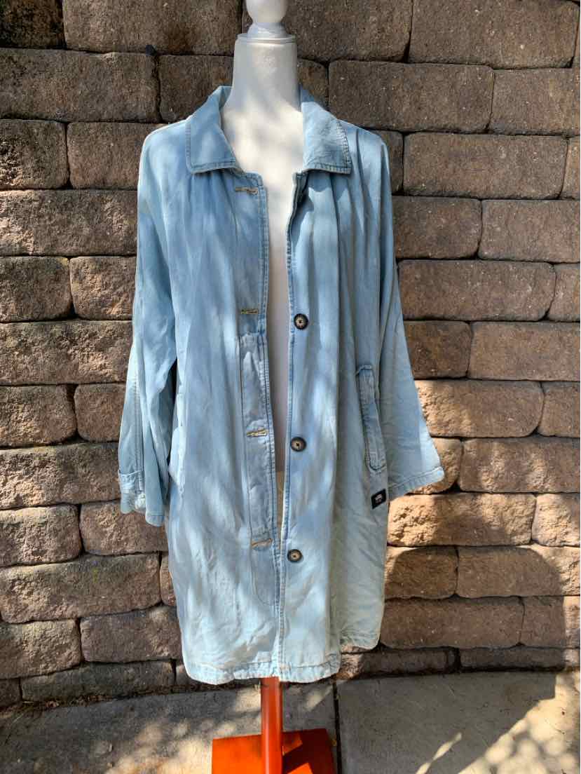 Light blue oversized denim jacket with large buttons and long sleeves on a mannequin.