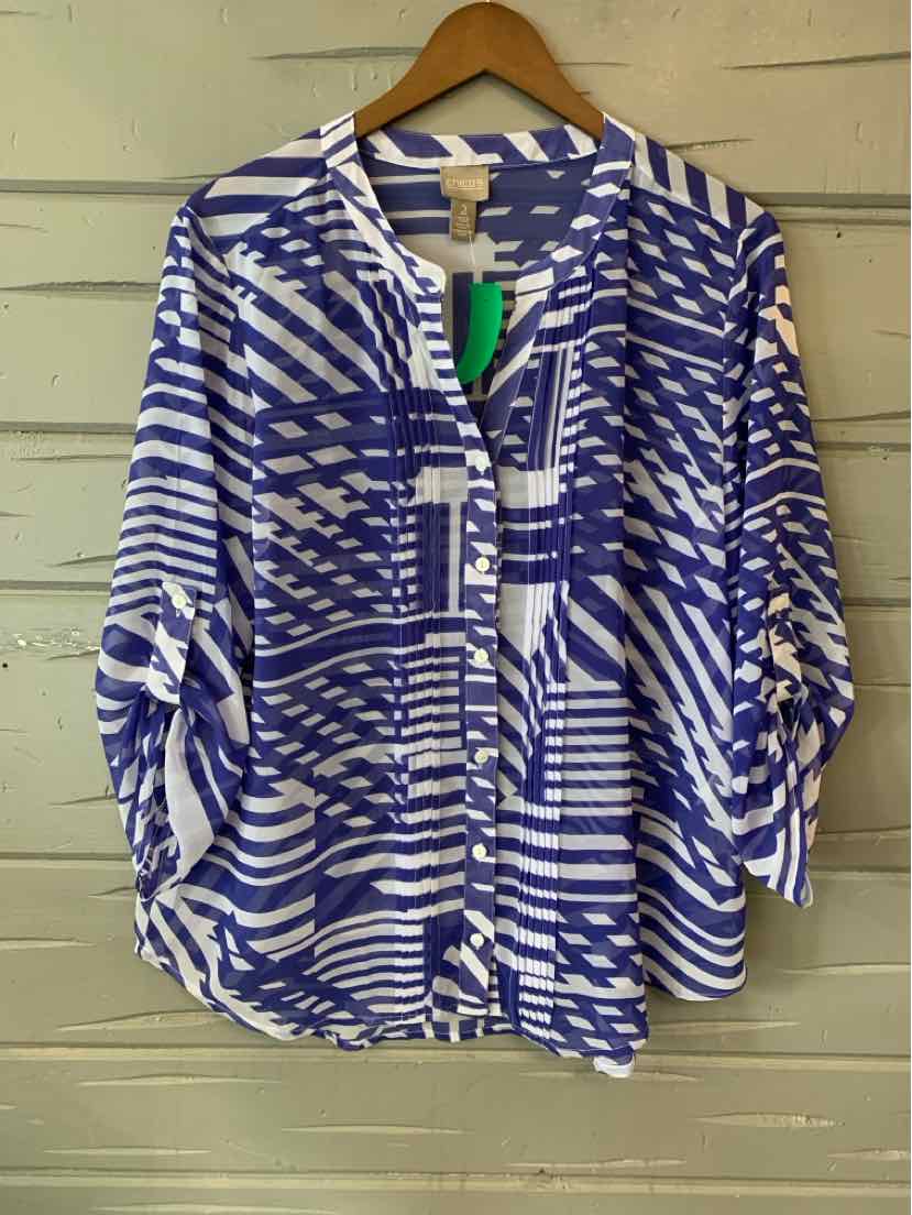 Blue and white geometric patterned loose blouse with roll-tab sleeves and buttoned front.