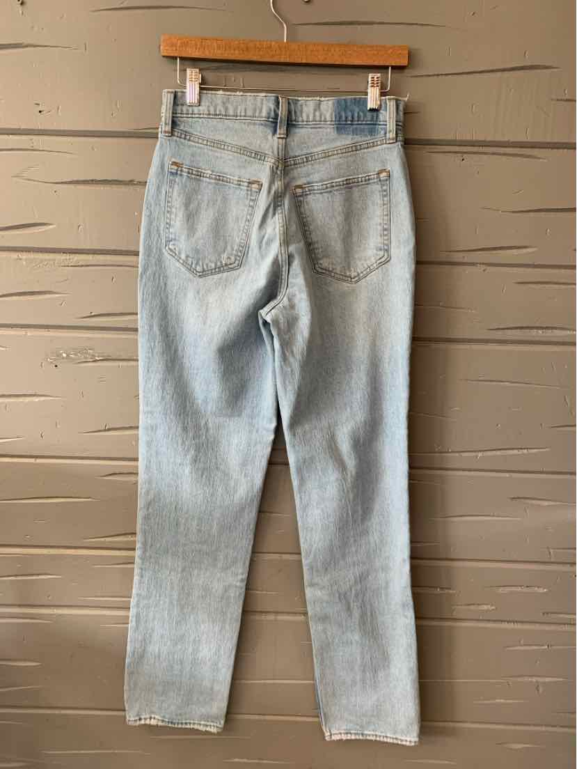 Light wash slim-fit denim jeans with back pockets and belt loops, size 4.