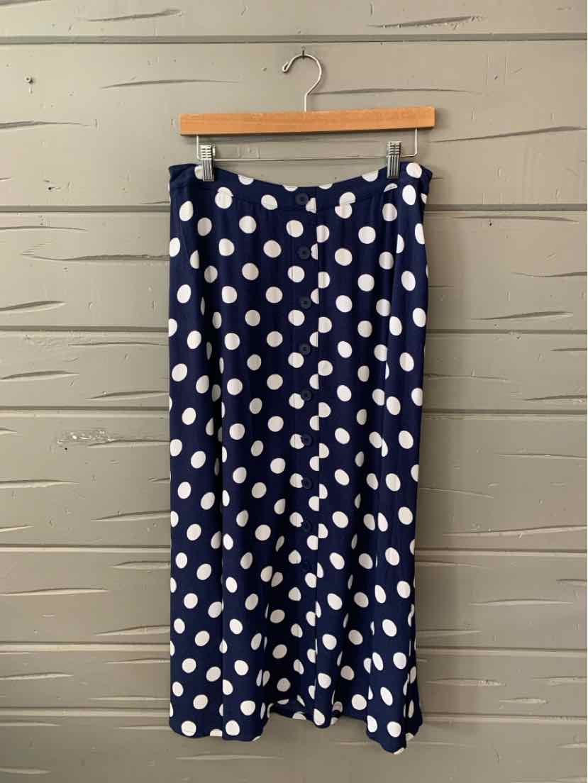 Navy blue midi skirt with white polka dots and a slight flare at the hem.