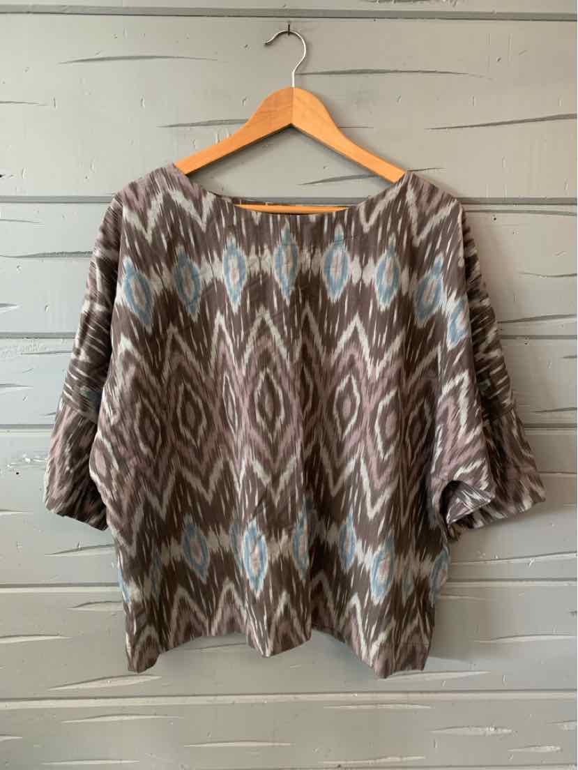 Brown and gray ikat-patterned blouse with blue diamond accents, loose fit, three-quarter sleeves.