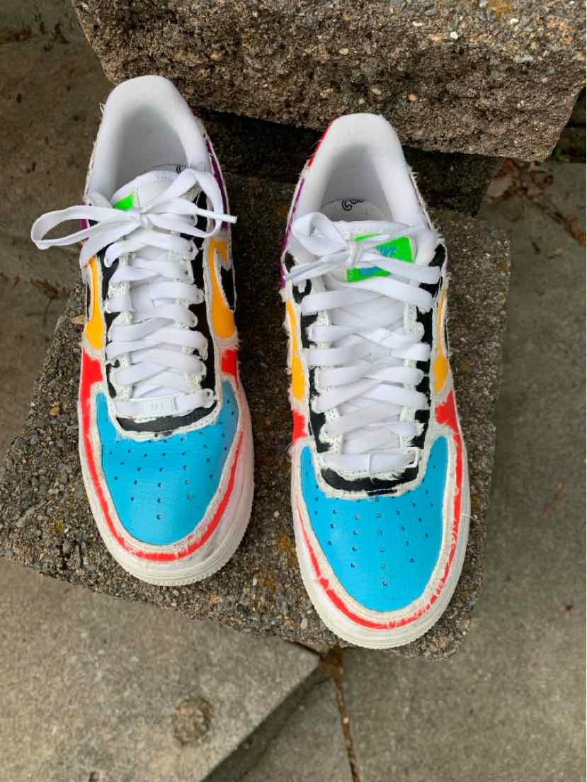 Pair of Nike multi-color sneakers with bright blue perforated toe panels, white laces, and orange-red trim.