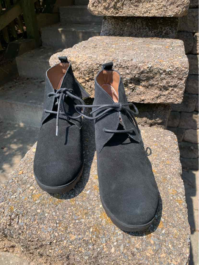 Black suede ankle boots with rounded toes, lace-up front, and low block heels.