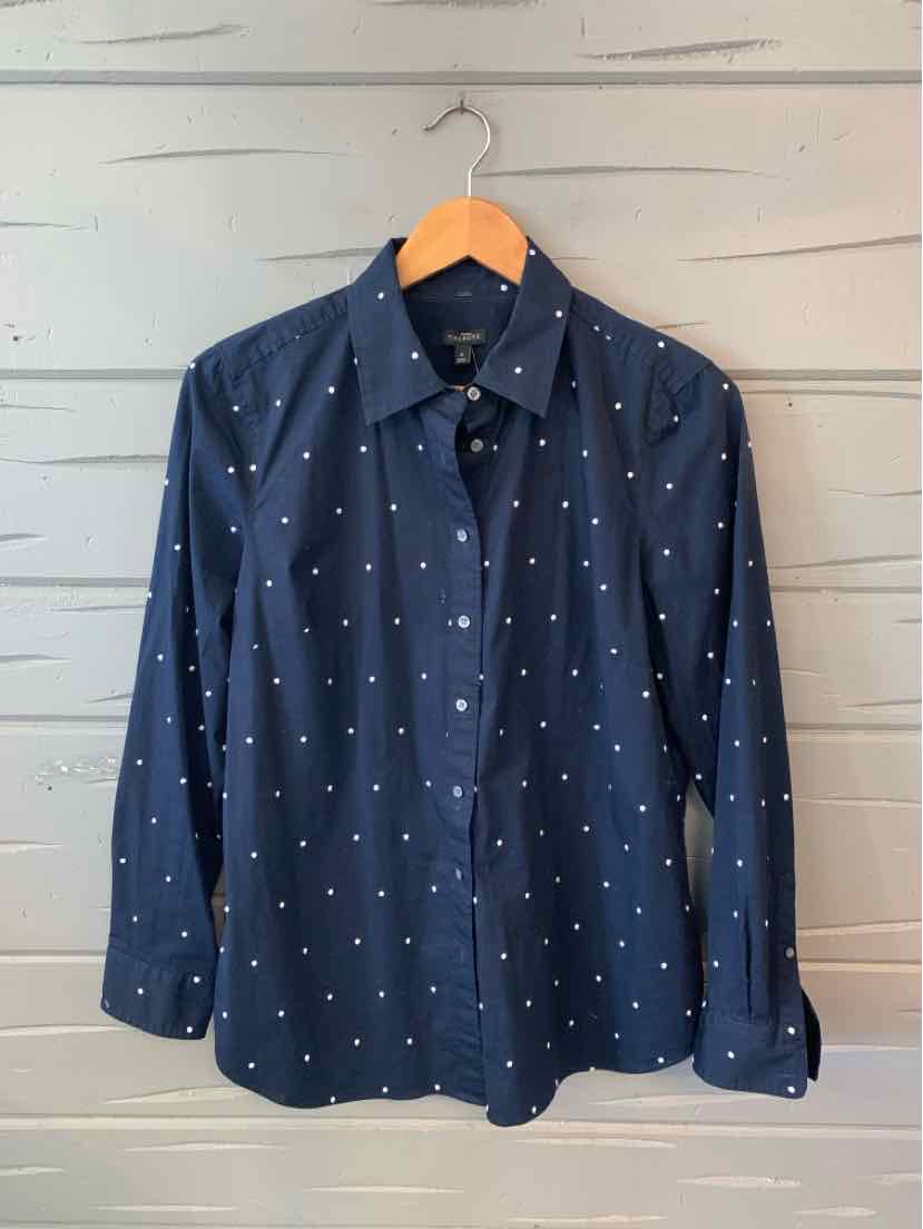 Navy blue long-sleeve button-up shirt with white polka dots, collar, and pocket.