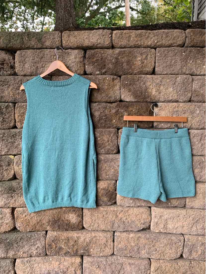 Two-piece women's turquoise lounge set with a sleeveless top and matching drawstring shorts in soft knit fabric.