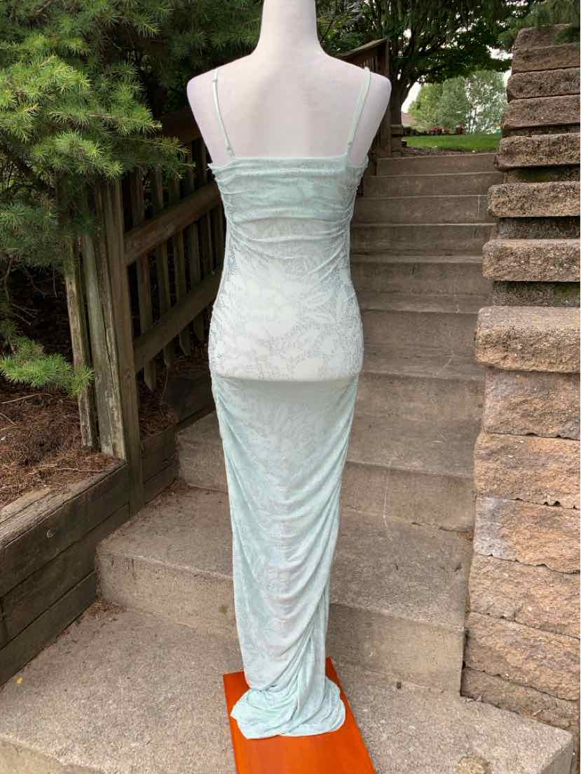 Mint green fitted dress with thin straps and a subtle textured pattern, floor-length silhouette.