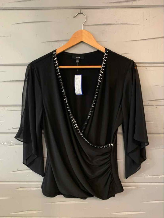 Black women's wrap-style top with a draped neckline, silver chain trim, and flowing three-quarter sleeves.