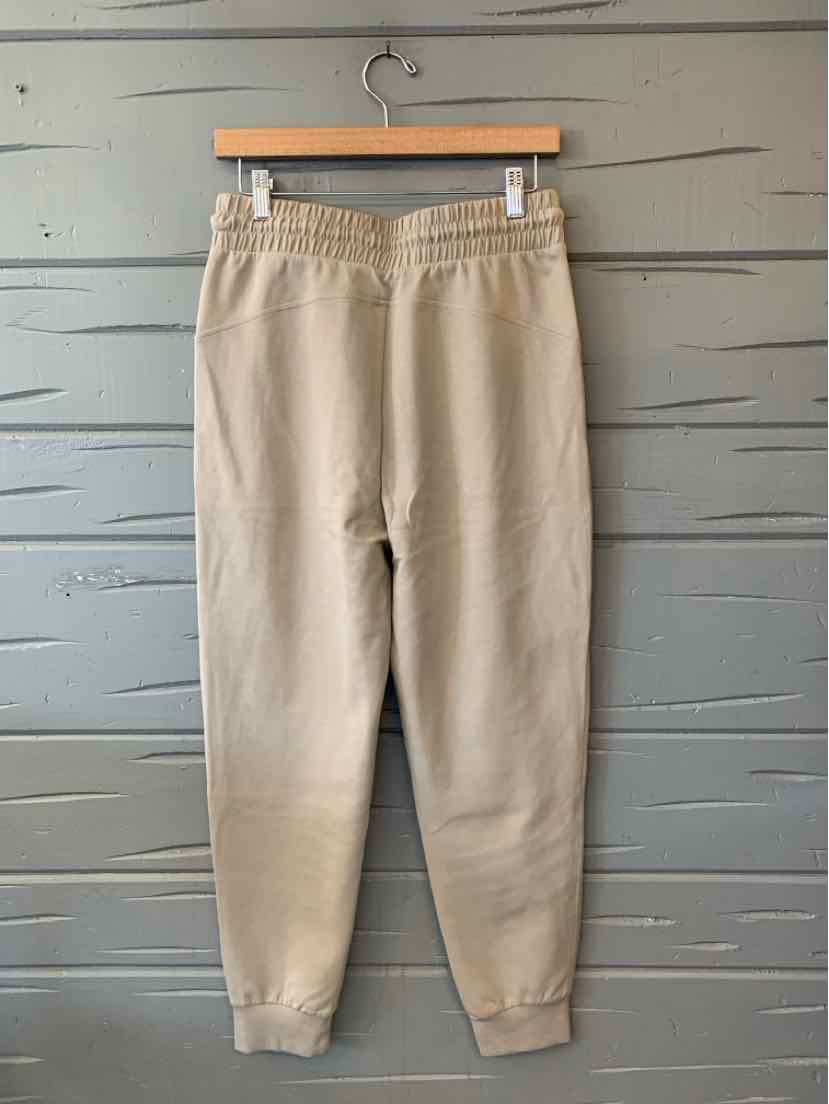 Beige Old Navy jogger pants with an elastic waistband, tapered legs, and ribbed ankle cuffs.