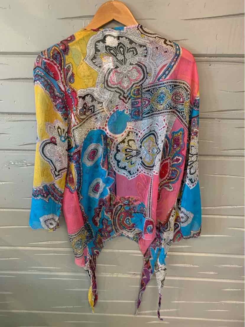 Colorful paisley patterned blouse with yellow, blue, pink, and white sections, loose fit with tie details at the hem.