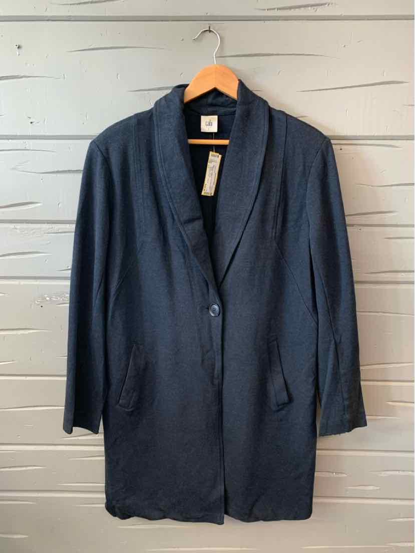 Dark gray oversized blazer with single-button closure and notch lapel collar hanging on wooden hanger.