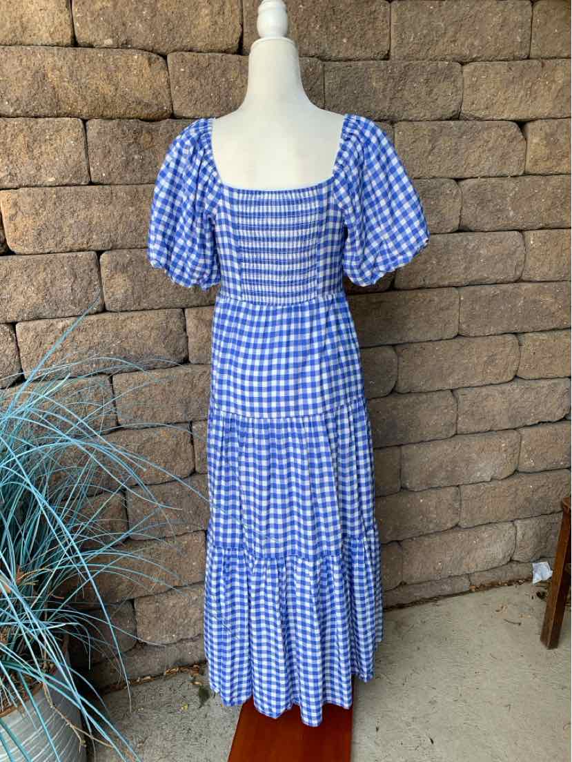 Blue and white gingham midi dress with puff sleeves, square neckline, and tiered skirt.