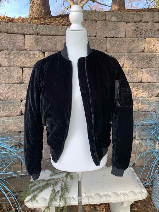 Black velvet bomber jacket with zip front and ribbed cuffs on mannequin.