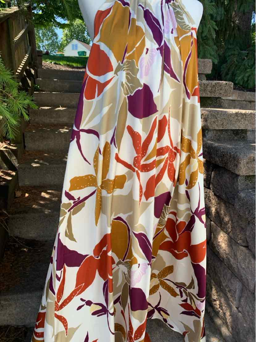 Flowy skirt with large orange, purple, and beige floral print on cream background, size 10.